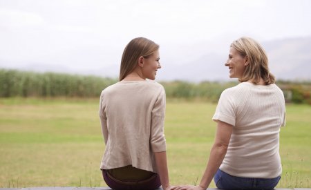 Mother and daughter sitting and together
